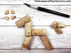 several pieces of cork next to a knife on a white wooden table with wood shavings