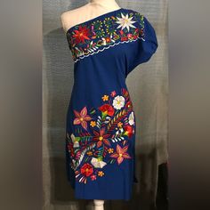 This Is A Beautifully Embroidered Dress With Amazing Colors That Match Perfectly With The Royal Blue!! One Shoulder Makes It Look Gorgeous, Elegant And Sexy. Comes With Straps On Each Side So You Can Tie And Adjust To Your Body And Comfort And Slits On Each Side. Size M New Without Tags Made In Mexico Blue Floral Print Embroidered Summer Dress, Summer Blue Embroidered Floral Print Dress, Spring Blue Embroidered Mini Dress, Blue Cotton Dress With Embroidered Hem, Blue Cotton Dress With Floral Embroidery, Traditional Blue Embroidered Dress With Embroidered Hem, Traditional Blue Dress With Embroidered Hem, Blue Floral Embroidery Short Sleeve Dress, Blue Dresses With Embroidered Hem