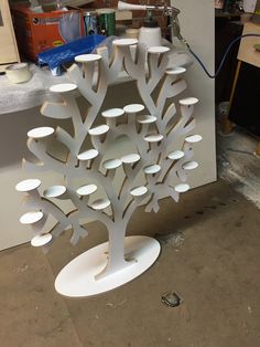 a white tree sculpture sitting on top of a table