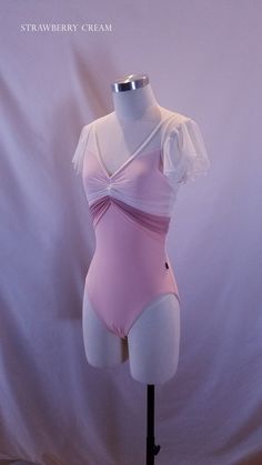 a female mannequin wearing a pink swimsuit with ruffles on it