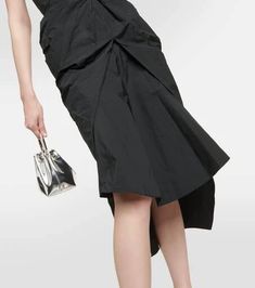 Defined by its distinctive architectural draping, the Fincher dress from Maticevski is one to make a lasting imprint. The classic black model is topped with a structured strapless bustier top and a cinched waist which glides down to an asymmetric knee-length hemline..Material: 59% polyester, 41% polyamide.Care instructions: dry clean.Made in Australia.Designer color name: Noir.Lining: 93% silk, 7% elastane.Closure: zipped back.True to size.Strapless.Internal boned corset for support.Cinched wais Black Formal Draped Skirt, Black Draped Skirt With Asymmetrical Hem For Formal Occasions, Black Asymmetrical Draped Skirt For Formal Occasions, Elegant Knee-length Draped Skirt For Spring, Chic Evening Draped Knee-length Skirt, Evening Pleated Draped Skirt, Pleated Draped Skirt For Evening, Chic Black Draped Skirt With Ruched Detail, Elegant Evening Pleated Draped Skirt