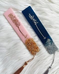 two different items are laying on a white furnishing with tassels attached to them