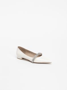 Editor's NoteCHAUSSURE LAPIN's shoes can be styled with a more elevated look.- Shiny jewel strap point- Basic flat heel finished in leather- Flat with a strap on the instep for a stable fit- Made with a standard, regular size lastMeasurements(in.)- Size: KR 220MM - KR 260MM (US 5 - 9)- Heel Height: 0.59 in.*Fits true to the size. Composition & Care- Upper: Cow Leather / Lining: Sheep Leather- Natural leather may have fine scratches and wrinkles- Bright leather can get stained by de Formal Almond Toe Flats With Heel Strap, Elegant Flat Court Shoes For Evening, Elegant Flat Evening Court Shoes, Elegant Closed Toe Flats With Rhinestones, Elegant Low Heel Flats With Rhinestones, Elegant Low-heel Flats With Rhinestones, Elegant Flat Court Shoes, Elegant Pointed Toe Flats With Removable Insole, Formal Closed Toe Flats With Rhinestones