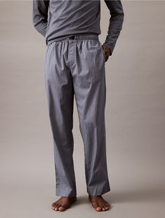 Crafted from 100% cotton, these pants are breathable with a lightweight feel. Cut with a mid rise waist and detailed with slip pockets at the sides. Finished with a Calvin Klein logo tag at the center waist.  Material: 100% Cotton. Accessories Logo, Sleep Pants, Mens Fashion Casual Outfits, Logo Tag, Classic Shoes, Lounge Pants, Logo Tees, Iconic Brands, Mens Fashion Casual