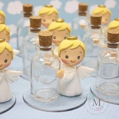 tiny angel figurines in glass bottles with cork tops