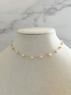 "Pearl Necklace - made from porcelain pearls, detailed on an 18k gold filled chain, and has an extender chain attached for different lengths.   This simple and dainty Pearl necklace is perfect for everyday wear- even into the night! Necklace length: 15 3/4\" with 2\" extender Porcelain Pearl Size: 4mm Material: 18k Gold Filled Chain" Minimalist Pearl Jewelry, Gold Single Strand Baroque Pearl Jewelry, Gold Pearl Pendant Necklace In 14k Gold Filled, Adjustable Baroque Pearl White Jewelry, Baroque Pearl White Jewelry With Adjustable Chain, Pearl White Baroque Pearl Jewelry With Adjustable Chain, Gold Jewelry With Adjustable Chain And Baroque Pearl, Gold Bohemian Jewelry With Adjustable Baroque Pearl Chain, 14k Gold Filled Pearl Chain Necklace