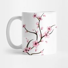 a white coffee mug with pink flowers on it