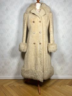 A beautiful double-breasted coat made of sheep fur, finished with real soft fur on the collar, cuffs and at the bottom. An incredibly rare item from the 1970s. The flathead is in almost perfect condition, with normal traces of use. There are no ugly spots and it is well preserved. You won't get cold in this coat and you will definitely be noticed, the interesting texture of the fur attracts attention with its slight shine - pearl color. I highly recommend it. A truly stylish thing. Dimensions: sleeve from the collar: 73 cm armpit sleeve:43  cm in the bust: 2x 46 cm waist: 2x 42 cm in the hips: 2x  47cm total length: 104 cm Cream Fur Coat With Faux Fur Lining, Cream Faux Fur Coat With Faux Fur Lining, Fitted Long Wool Coat With Faux Fur Trim, Cream Fur Coat With Faux Fur Trim For Winter, Winter Cream Fur Coat With Faux Fur Trim, Cream Faux Fur Coat For Winter, Cream Sheepskin Fur Coat For Winter, Cream Long Fur Coat With Faux Fur Lining, Cream Fitted Fur Coat With Faux Fur Trim