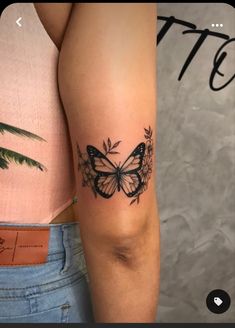 a woman's arm with a butterfly tattoo on the left side of her arm