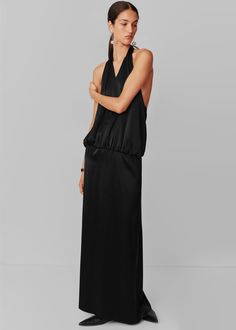 Color: Black Midweight satiny fabric Relaxed fit Maxi length Halter neck Low scoop back Drop waist Back tie closure Unlined 80% Naia Acetate 20% Polyester Dry Clean By Esse Studios. Made in Australia Sleek Evening Maxi Dress With Tie Back, Sleek Silk Satin Dress With Back Opening, Satin Maxi Dress With Back Opening For Cocktail, Sleek Tie-back Dress, Chic Backless Silk Dress, Sleek Modal Satin Maxi Dress For Formal Occasions, Silk Halter Neck Maxi Dress For Night Out, Sleek Modal Satin Maxi Dress For Formal Events, Chic Satin Maxi Dress With Back Opening