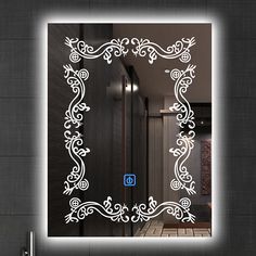 a bathroom mirror with an illuminated frame in the shape of a flower pattern on it