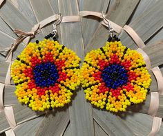 These beautiful handmade Huichol beaded earrings are made in Tulancingo Hidalgo, Mexico. Each pair are uniquely hand crafted with uniquely designed they are also lightweight. Ready to ship! Yellow Beaded Earrings With Ear Wire For Festivals, Handmade Yellow Beaded Bohemian Earrings, Bohemian Beaded Round Flower Earrings, Artisan Multicolor Round Beaded Earrings, Traditional Multicolor Flower Earrings With Dangling Beads, Handmade Yellow Beaded Earrings For Festival, Artisan Beaded Earrings With Round Beads For Festivals, Traditional Multicolor Earrings With Large Beads, Traditional Round Beaded Earrings With Large Beads