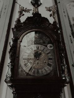 an old clock is hanging on the wall