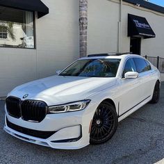 a white car parked in front of a building