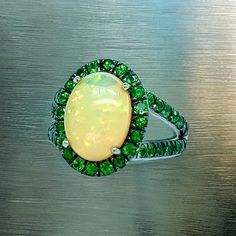 Natural Quality Opal Tsavorite Ring Size 7 14k Gold 5.66 TCW Certified $5,950 300686This is a one of a Kind Unique Custom Made Glamorous Piece of Jewelry!Nothing says, “I Love you” more than Diamonds and Pearls!This item has been Certified, Inspected, and Appraised by Gemological Appraisal LaboratoryGemological Appraisal Laboratory of America is a proud member of:- GIA Alumni Association- National Association of Jewelry Appraisers- International Consortium Gem-Testing Laboratories- Gemological A Oval Multi-stone Tsavorite Rings, Oval Tsavorite Multi-stone Ring, Gia Certified Green Oval Sapphire Ring, Green Multi-stone Sapphire Ring For May Birthstone, Gia Certified Green Tsavorite Rings, Oval Tsavorite Jewelry With Accent Stones, Oval Green Tsavorite Jewelry, Oval Green Sapphire Ring With Halo Setting, Oval Tsavorite Rings With Halo Setting