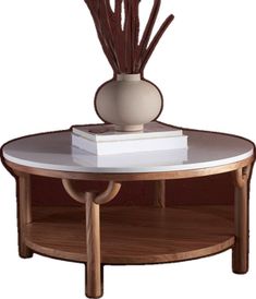 a table with a vase and some books on it