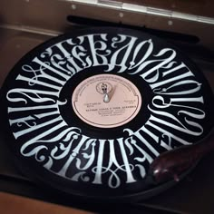 a black and white clock with writing on it