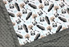 a close up of a blanket with an owl pattern on it