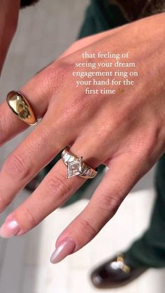 a woman's hand with two gold rings on it and a quote from the book that reads, that feeling of seeing your dream engagement ring on every first time