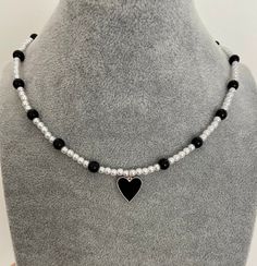 'Black heart' - modern combination of 3 mm glass pearl, 6 mm black onyx bead and black enamel heart pendant. The necklace is 15 inch in length + 1.5 inch extender. Elegant Adjustable Black Heart Necklace, Black Adjustable Heart Charm Necklace, Adjustable Black Heart Charm Necklace, Adjustable Black Heart Pendant Necklace, Trendy Black Beaded Necklace Gift, Black Necklace With Adjustable Heart Charm, Adjustable Black Necklace With Heart Charm, Black Heart Beads Necklace For Valentine's Day, Black Adjustable Heart Pendant Necklace