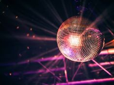 a disco ball hanging from the ceiling with bright lights