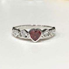 Vintage Sterling Silver Garnet & White Topaz Heart Ring ...Marked 925...Total of weights 2.1grams...Size 9...Measure of Face 6.2MM...It's in very good condition. Heart Engagement Rings Silver, Valentine's Day Diamond Heart Ring, Hallmarked, Heart-shaped White Gold Birthstone Ring For Valentine's Day, Silver Heart Cut Ring For Anniversary, Silver Heart Cut Ring For Anniversary Gift, Valentine's Day Diamond Heart Ring Hallmarked, White Gold Heart Cut Rings For Anniversary Gift, Heart Cut Topaz Birthstone Ring For Anniversary, Valentine's Day Hallmarked Diamond Heart Ring