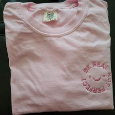 Embroidered Comfort Colors® Tee  ✿ ❀ ✿ ❀ ✿   HOW TO ORDER   ✿ ❀ ✿ ❀ ✿ ▷ Choose t-shirt size and color ▷ Include thread color in the personalization box ▷ Double check measurements ▷ Add to Cart  ✿ ❀ ✿ ❀ ✿   SIZES   ✿ ❀ ✿ ❀ ✿ These shirts are unisex sizing, please refer to the size chart in the pictures to determine the correct size. If you need a different shirt size, color or thread color, please feel free to reach out and I'll let you know if it's possible. ✿ ❀ ✿ ❀ ✿   CARE INSTRUCTIONS   ✿ ❀ ✿ ❀ ✿ - Turn garment inside out - Machine wash cold with mild detergent - No bleach, no fabric softener - Tumble dry low, hang dry preferred - Do not dry clean *These instructions help the design to remain in great condition but please follow the garment's washing instructions as well* ✿ ❀ ✿ ❀ ✿   S Cheap Pink Embroidered T-shirt, Be Real Not Perfect, Real Not Perfect, Self Love Shirt, Inspirational Tees, Comfort Colors Shirt, Be Real, Comfort Colors Tee, Love Shirt