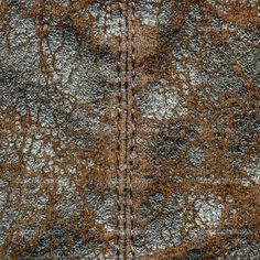 the texture of an old carpet with brown and white patterns is shown in close up