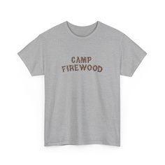 Inspired by the iconic summer camp in the cult classic movie Wet Hot American Summer. This vintage-style t-shirt features the classic Camp Firewood logo on a soft, comfortable fabric that will make you feel like you're ready to hit the bunk beds and relive those summer camp memories. Whether you're a die-hard fan of the movie or just love the retro camp aesthetic, this t-shirt is the perfect addition to your wardrobe. So grab your bug spray and your s'mores, and get ready to channel your inner camp counselor in style with the Camp Firewood t-shirt. .: 100% cotton.: Classic fit.: Tear-away label.: Runs true to size S M L XL 2XL 3XL Width, in 17.99 20.00 21.97 23.98 25.98 27.99 Length, in 28.00 29.00 30.00 31.00 32.00 33.00 Sleeve length (from center back), in 15.75 16.93 18.50 20.08 21.65 2 Summer Camping Graphic Tee, Summer Graphic Tee For Camping, Cotton T-shirt With Letter Print For Camping, Graphic Tee With Text Print For Camping, Pre-shrunk Cotton Camp Shirt For Camping, Camping Cotton T-shirt With Screen Print, Camping Cotton Screen Print T-shirt, Cotton Graphic Tee Camp Shirt With Letter Print, Cotton Screen Print T-shirt For Camping