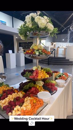 an assortment of fruits and vegetables on a buffet table at a wedding cocktail hour event