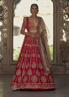 Make a striking impression in this red raw silk lehenga choli, complemented by a net dupatta embroidered in gold dori and highlighted with dabka, beads, sequins, and crystals. It comes with a second beige dupatta and belt. Raw Silk Lehenga, Anamika Khanna, Diana Penty, Bridal Lehenga Red, Red Lehenga, Embroidered Lehenga, Indian Wedding Wear, Sonakshi Sinha, Sara Ali Khan