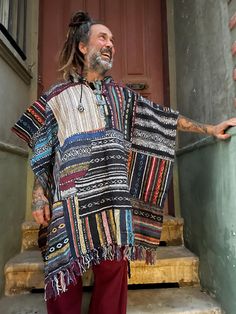 Wrap yourself in vibrant colors and bohemian style with this handmade Nepal Boho Patchwork Poncho. Crafted from 100% Gheri cotton, each poncho is individually hand-stitched, making every piece as unique as you are. The colorful patchwork design showcases traditional Nepalese craftsmanship, offering a one-of-a-kind look. With a roomy hood, wooden toggle buttons, and a front kangaroo pocket, this poncho is perfect for festivals, outdoor adventures, or simply cozying up at home. Designed for comfort and versatility, it's your go-to piece for year-round warmth and style. 📌Features: Material: 100% Handwoven Gheri Cotton Design: Colorful patchwork, each piece is unique Fit: One size, relaxed and roomy Hood: Adjustable hood with drawstrings Details: Wooden toggle buttons, large front pocket Sust Bohemian Handmade Cape Shawl, Handmade Bohemian Cape Shawl, Casual Oversized Multicolor Poncho, Bohemian Handwoven Poncho For Festival, Handmade Bohemian Cape One Size, Handmade One Size Bohemian Cape, Handmade Bohemian One-size Cape, Bohemian Handwoven One-size Cape, Bohemian One-size Handwoven Cape