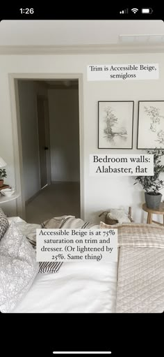 a bed room with a neatly made bed and pictures hanging on the wall above it