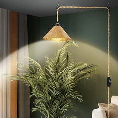 a potted plant sitting on top of a wooden table next to a lamp shade