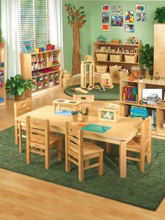 a child's playroom with wooden tables, chairs and shelves filled with toys