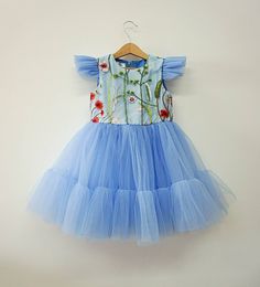 Perfect pale blue tulle dress for toddlers for celebrating wedding, first birthday and many other events. --- -Description- Material - soft dusty blue tulle Sleeve - short butterfly sleeves Lining - soft 100% cotton lining Length - knee length --- Sizes available: 6-9 months 9-12 months 12-18 months 1T 2T 3T 4T 5T Please, feel free to contact me if you have any questions. Blue Floral Applique Dress For Dress-up, Blue Tulle Dress With Short Sleeves, Blue Tulle Dress For Summer, Light Blue Tulle Dress With Floral Applique, Light Blue Tutu Dress For Summer Dress-up, Fitted Blue Princess Dress With Floral Applique, Blue Fairy Dress For Spring Wedding, Elegant Light Blue Princess Dress For Spring, Blue Tulle Fairy Dress For Wedding