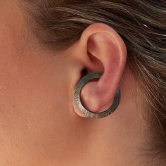 Here you may see a truly modern cuff that will definitely make a statement on your ear! Hoops with a special twist. You may wear it all day long as it comfortably stays stable. Of course, there is always the option to wear it as a big stud open circle earring! Black rhodium plated on raw sterling silver base with a satin finish. You just need an earlobe piercing to wear them and PLEASE BE ABSOLUTELY SURE THAT THE SIZE OF THE CUFF FITS YOUR EAR! Every ear is unique so please measure your ear befo Modern Ear Cuff For Pierced Ears As A Gift, Modern Ear Cuff As A Gift, Modern Cartilage Earrings With Ear Wire, Modern Ear Cuff For Gift, Modern Adjustable Single Wrap Earring, Modern Adjustable Single Cartilage Earring, Adjustable Modern Single Wrap Earring, Modern Handmade Ear Cuff For Gifts, Modern Everyday Nickel-free Ear Cuff