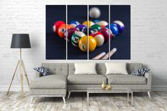 a living room with a couch, table and billiards balls on the wall