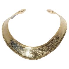 This 18 karat gold neck ring has a shiny, textured surface. The shape of the neck ring may be described as semi oval with an accentuated front. The neck ring's arms are equipped with square-shaped golden pillows on its ends. The neck ring looks like a piece of jewelry that could have been worn by an empress of the ancient Roman Empire. It radiates powerfulness and self-confidence and it is perfect for any social gathering. Do you know that Claës Giertta, in year 1969, designed the Swedish music Grammy Trophy, Golden Pillow, Ancient Roman Empire, Neck Rings, Neck Ring, Social Gathering, Ancient Romans, Roman Empire, Music Industry