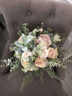 a bouquet of flowers sitting on top of a chair