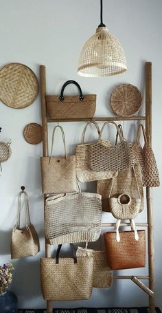 baskets and purses are hanging on the wall