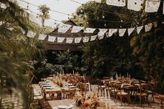 an outdoor dining area with tables and chairs set up for a wedding or other function