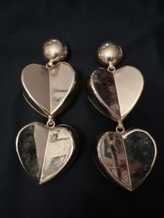 5 inches Clip on style gilded brass Double heart design  Great 1980's style Vintage Metal Heart Earrings For Valentine's Day, Vintage Metal Heart Earrings, Vintage Heart-shaped Earrings For Party, Vintage Double Heart Earrings, Vintage Double Heart Pierced Earrings, Vintage Heart Shaped Earrings For Party, Vintage Heart Earrings For Party, Retro Gold Heart-shaped Earrings, Vintage Gold Heart Earrings For Valentine's Day