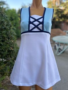 Here is a vintage 1970s polyester tennis dress.Made by Top Seed.Following  are the measurements. Bust 34",waist 30",hips 40",Length 29".Zips up the back.White skirt w Baby blue bodice.Navy Blue  Criss Cross design.One pocket on the back.In nice vintage condition Please take special consideration of measurements. 1970s sizing was very small to today's standards. Tennis dresses were very short not like a regular dress. So please take special note of length. If you live overseas please email me first before purchasing for mailing cost. Price quoted is for USA only Blue Tennis Dress For Spring, Spring Blue Tennis Dress, Blue Spring Tennis Dress, Fitted Cotton Tennis Dress, Spring Fitted Blue Tennis Dress, Fitted Blue Spring Tennis Dress, Fitted Blue Tennis Dress For Spring, Fitted Tennis Dress For Summer, Fitted Cotton Tennis Dress For Spring