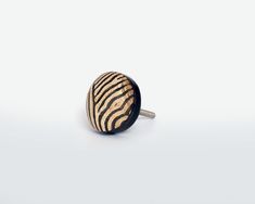 a zebra print wooden ring on a white background