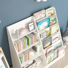 there is a book shelf with many books on it and a stuffed animal next to it