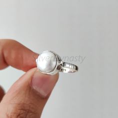 Stone : Pearl Metal : 925 Sterling Silver Stone Size : 10mm  Shape : Round Band Size : 2mm Ships worldwide from India 925 stamped Handmade Item STYLE STATEMENT Be it ethnic or casual wear, this ring is sure to add style to your look. Match it with any attire and stay trending at all times. CUSTOMIZATION We welcome customization.Change in gemstone or design as per your need can be done. The stone size can also be changed as per your need. We are just a message away OUR QUALITY * All our products Adjustable Minimalist Sterling Silver Pearl Ring, Everyday Simple Round Pearl Ring, Sterling Silver White Gold Pearl Ring, Minimalist Stackable Sterling Silver Pearl Ring, Everyday White Pearl Ring In Sterling Silver, White Gold Sterling Silver Pearl Ring, Everyday White Gold Pearl Ring In Sterling Silver, Everyday White Gold Sterling Silver Pearl Ring, Everyday Sterling Silver Pearl Ring In Silver