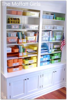 a bookcase filled with lots of books and plastic bins on top of it