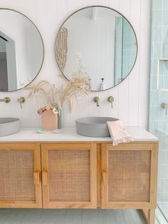 the bathroom is decorated in white and wood