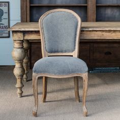 an old wooden chair sitting in front of a desk